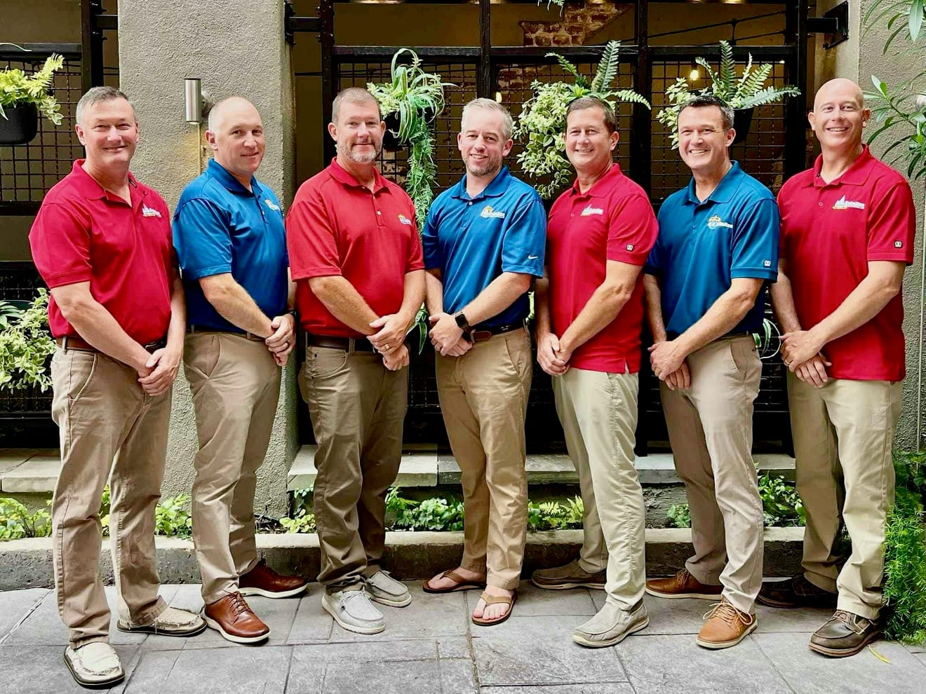 The fourth generation of A.C. Schultes leadership, seven men in company polo shirts